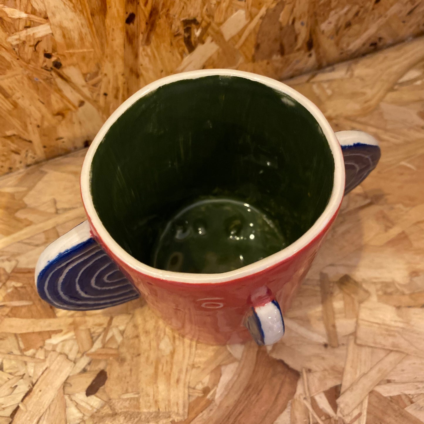 Red & green Head Mug by John Molesworth
